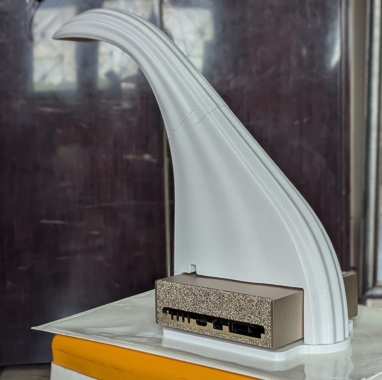The Disha Box prototype, photographed July 2026 — a white swan-neck clinical appliance with its dedicated AI engine in the base